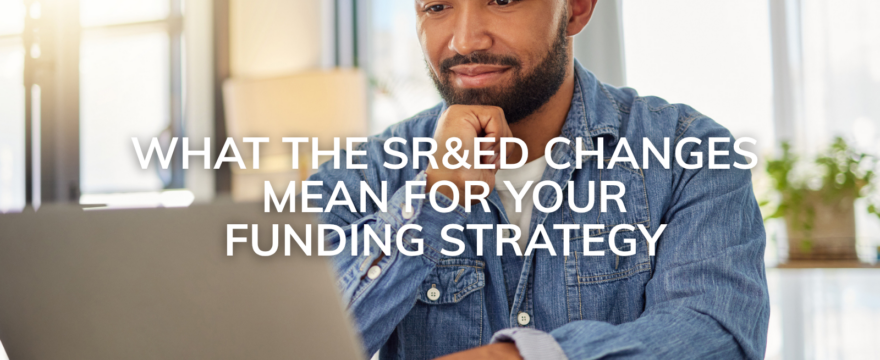 A man looks at a computer and contemplates his SRED strategy after the legislation updates