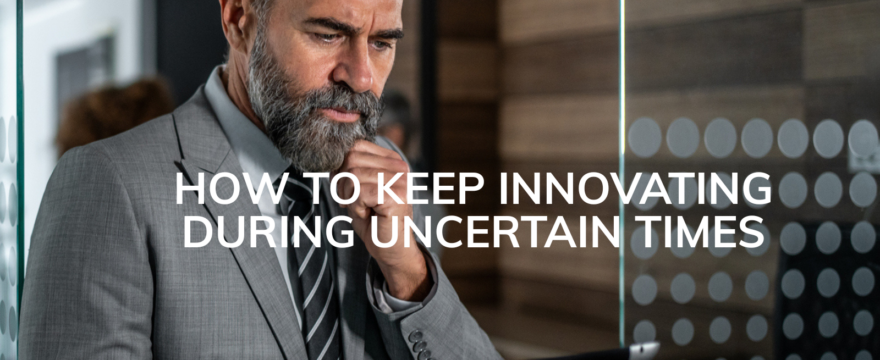 A bearded man in a suit look pensively